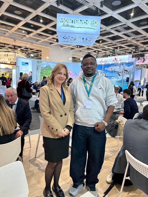 Standing with a representative of Montenegro's national tourism board at their ITB Berlin stand