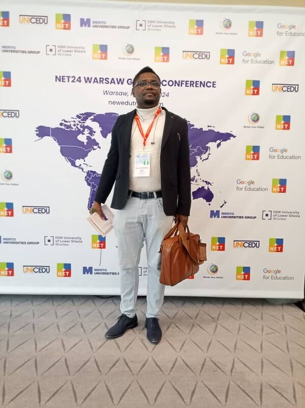 Standing in front of the NET24 Warsaw Global Conference backdrop
